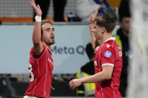 Wrexham overcome illness to cement playoff spot